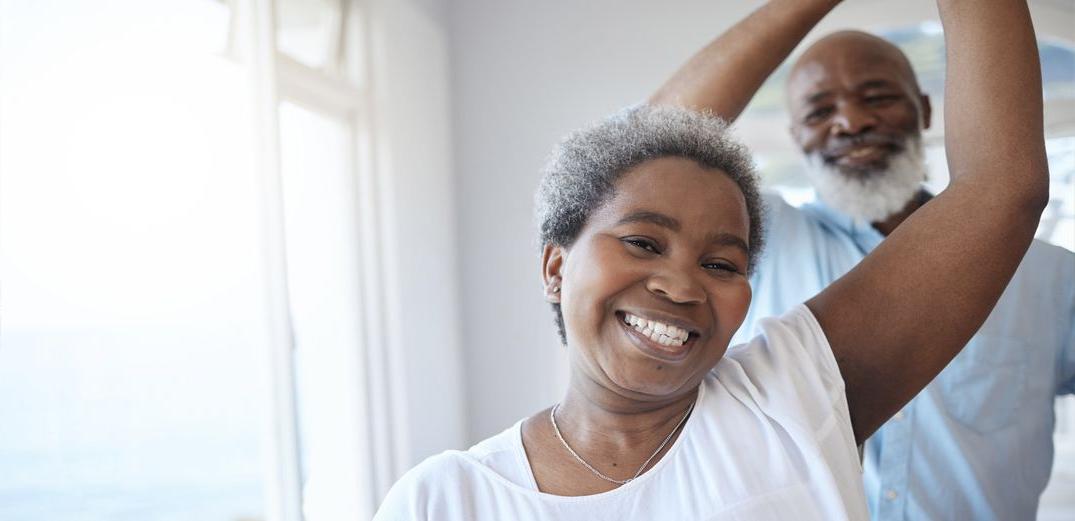 A happy retiree twirls his smiling dance partner.